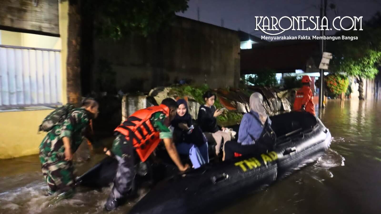 Personel Koramil 02 Mampang Prapatan dipimpin Mayor Inf Sugiyanto evakuasi warga korban banjir Pondok Karya menggunakan perahu karet LCR.