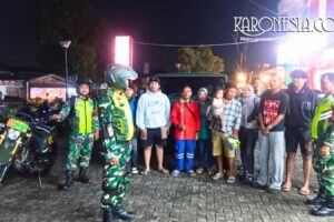 Anggota TNI berdialog dengan warga saat patroli keamanan di Bantar Gebang Bekasi