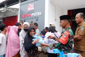 Personel Kodim 0507 Bekasi membagikan takjil kepada pengendara di Bojong Menteng