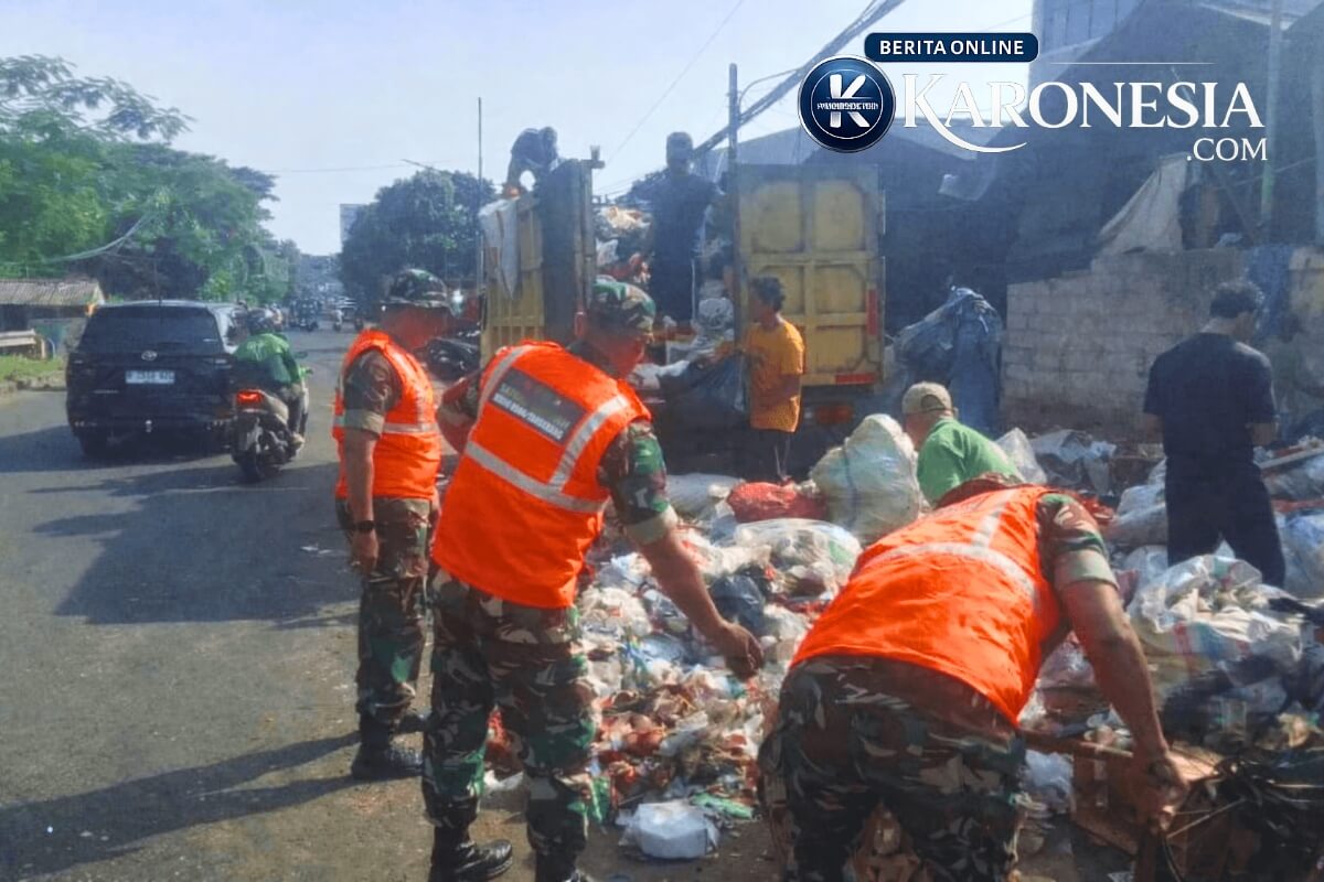 Personel TNI dan warga membersihkan sampah di Ciputat.