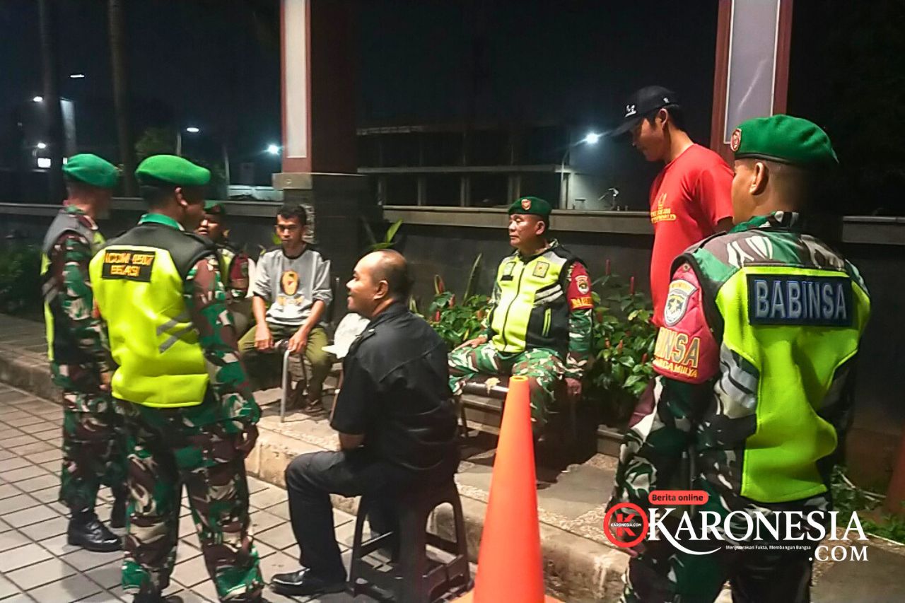 Babinsa Koramil Teluk Pucung berbincang dengan warga saat patroli malam