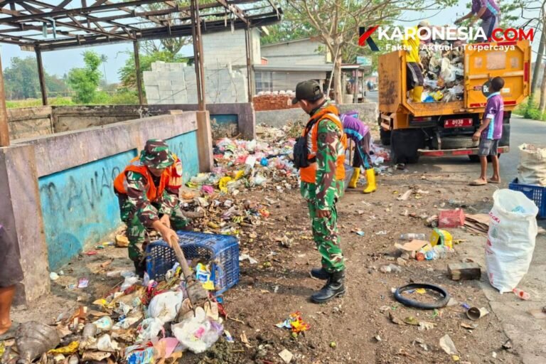 Personel Babinsa Koramil 09/Mauk bersama petugas DLH memilah dan mengangkut sampah ke dalam truk di Jalan Raya Tanjung Kait.