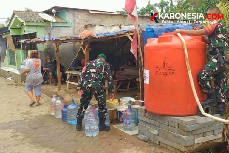 Personel Koramil 01 Tangerang mengisi tandon dan galon air warga saat penyaluran bantuan air bersih PDAM di Kunciran Jaya.